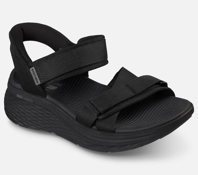 Skechers Slip Ins Max Cushioning Elite 2.0 Sandal Zoe on naisten sandaali, jossa yhdistyvät erittäin pehmeä Max Cushioning mukavuus, helppo pukeminen ja jalkaterää tukeva rakenne. Tämä Skechers sandaali on suunniteltu erityisesti kesäiseen kävelyyn, vapaa aikaan ja jokapäiväiseen käyttöön, kun kengältä halutaan keveyttä ja tehokasta vaimennusta.